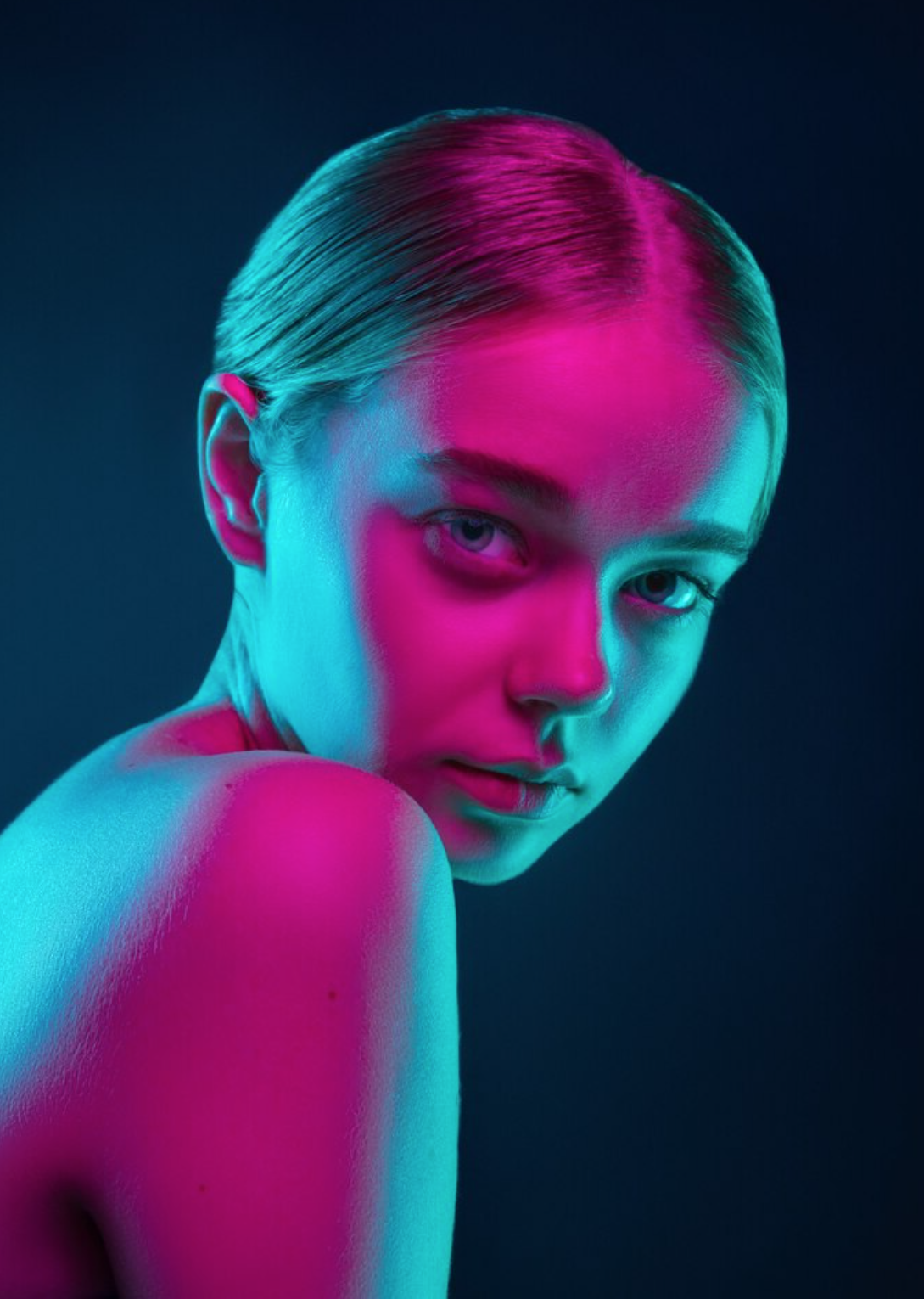 Blue and Red Light on Blonde Girl with a Blue Black background.