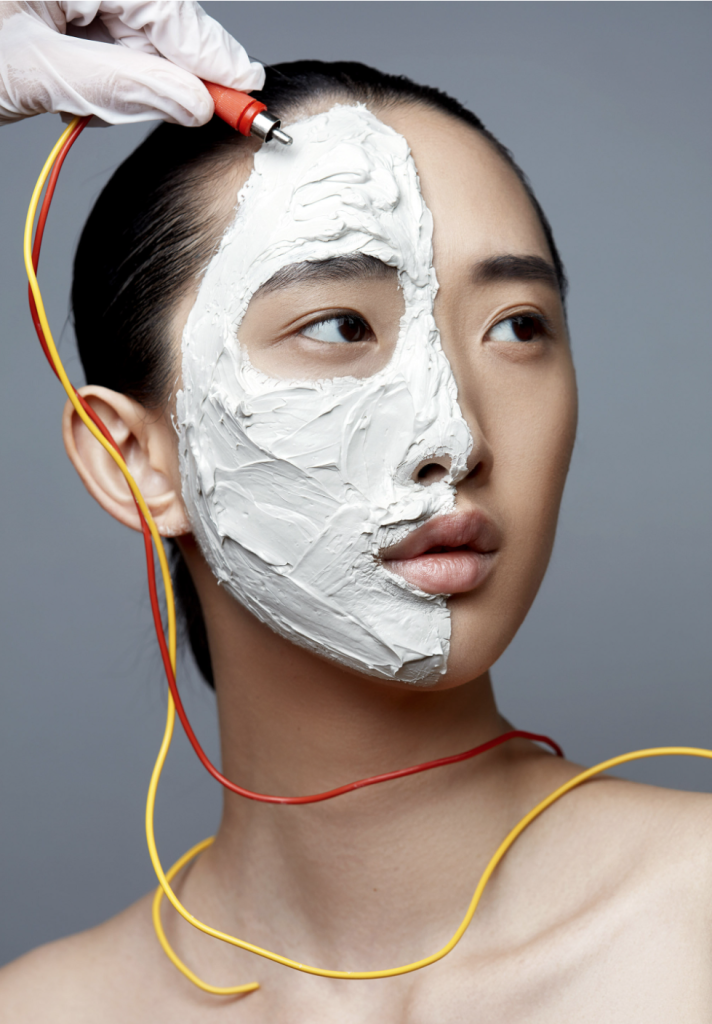 Cables around face of model with mask on one side.